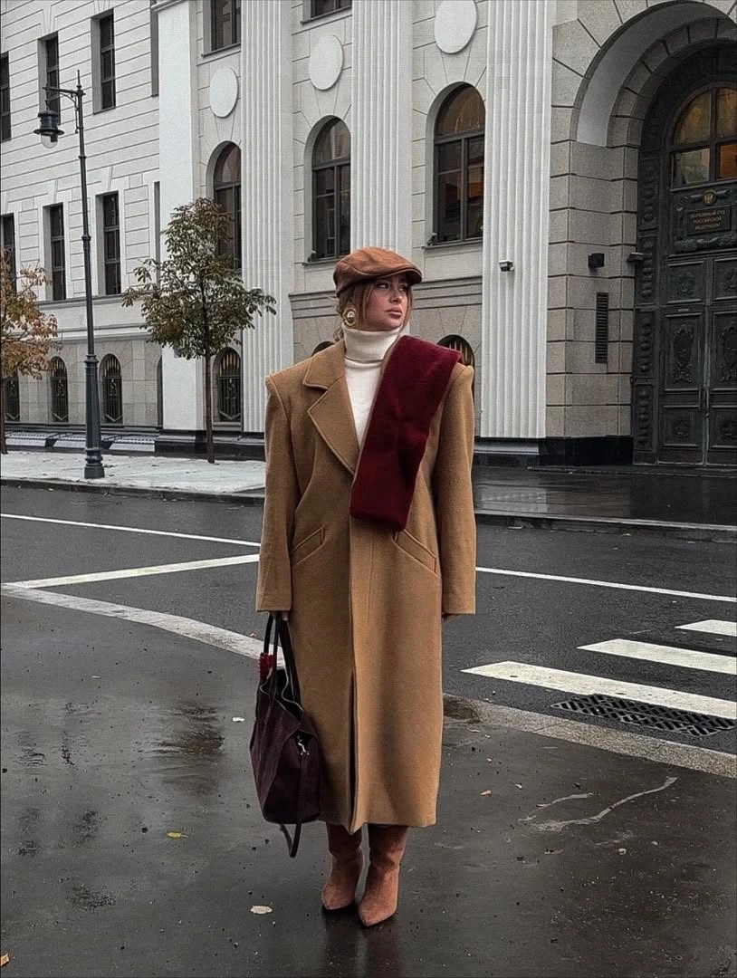 Camel coat with burgundy sweater scarf dark boots and bag