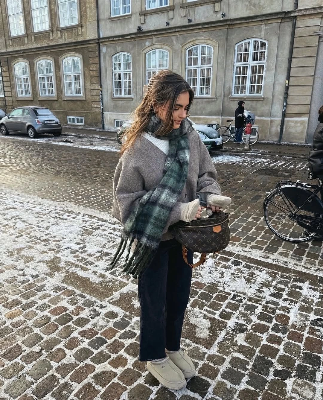 Gray sweater black wide trousers plaid scarf white sneakers and woven bag