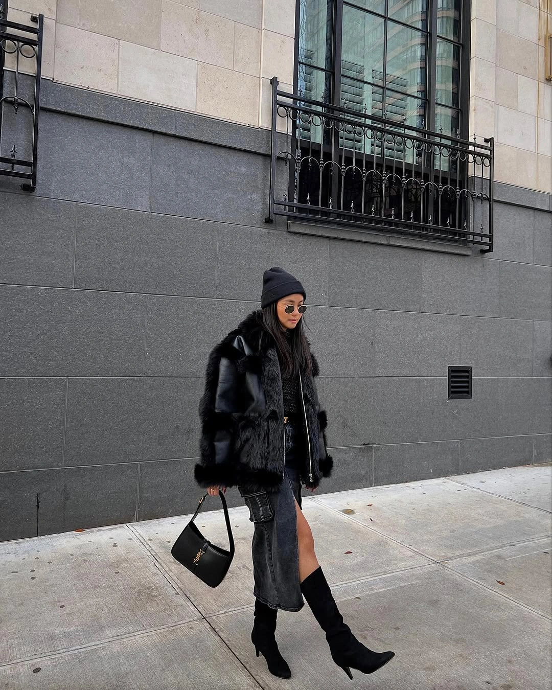 Black coat and beanie with gray wide trousers and black boots