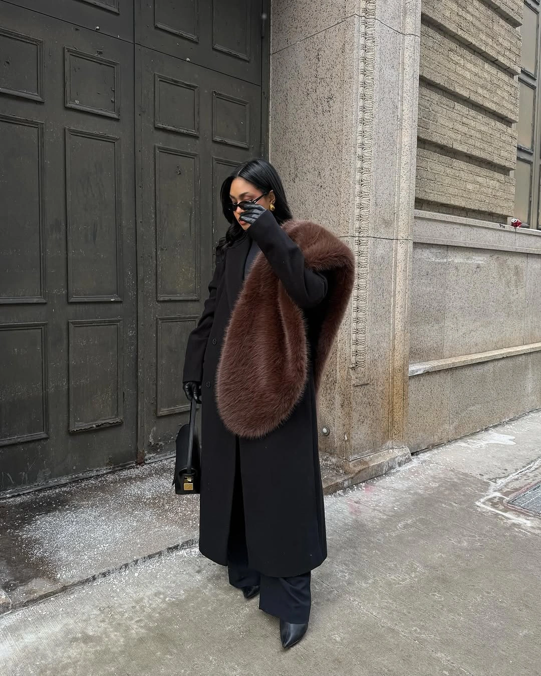 Long black coat with oversized brown textured stole and black boots