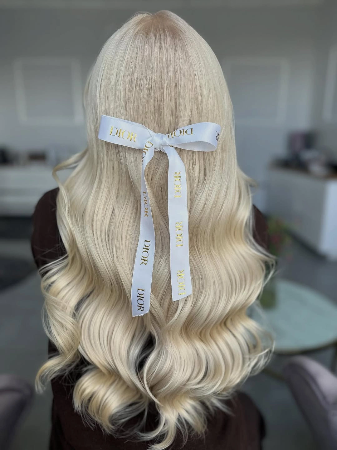 Long pale blonde waves with light ribbon bow
