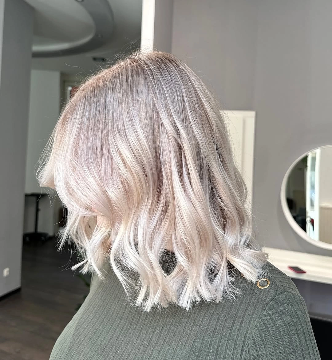 Wavy blush beige blonde lob from side