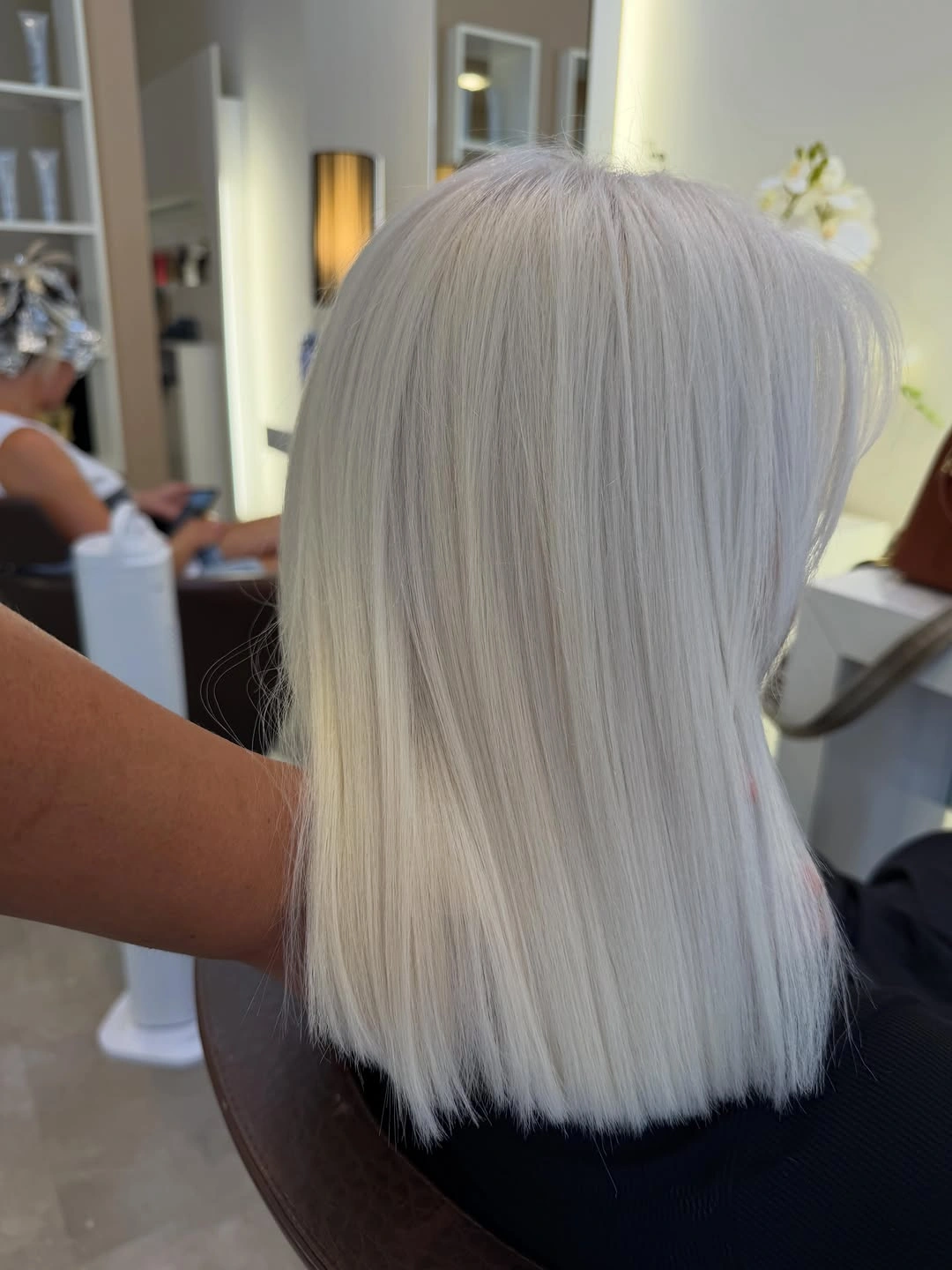 Short white blonde bob with blunt ends from back