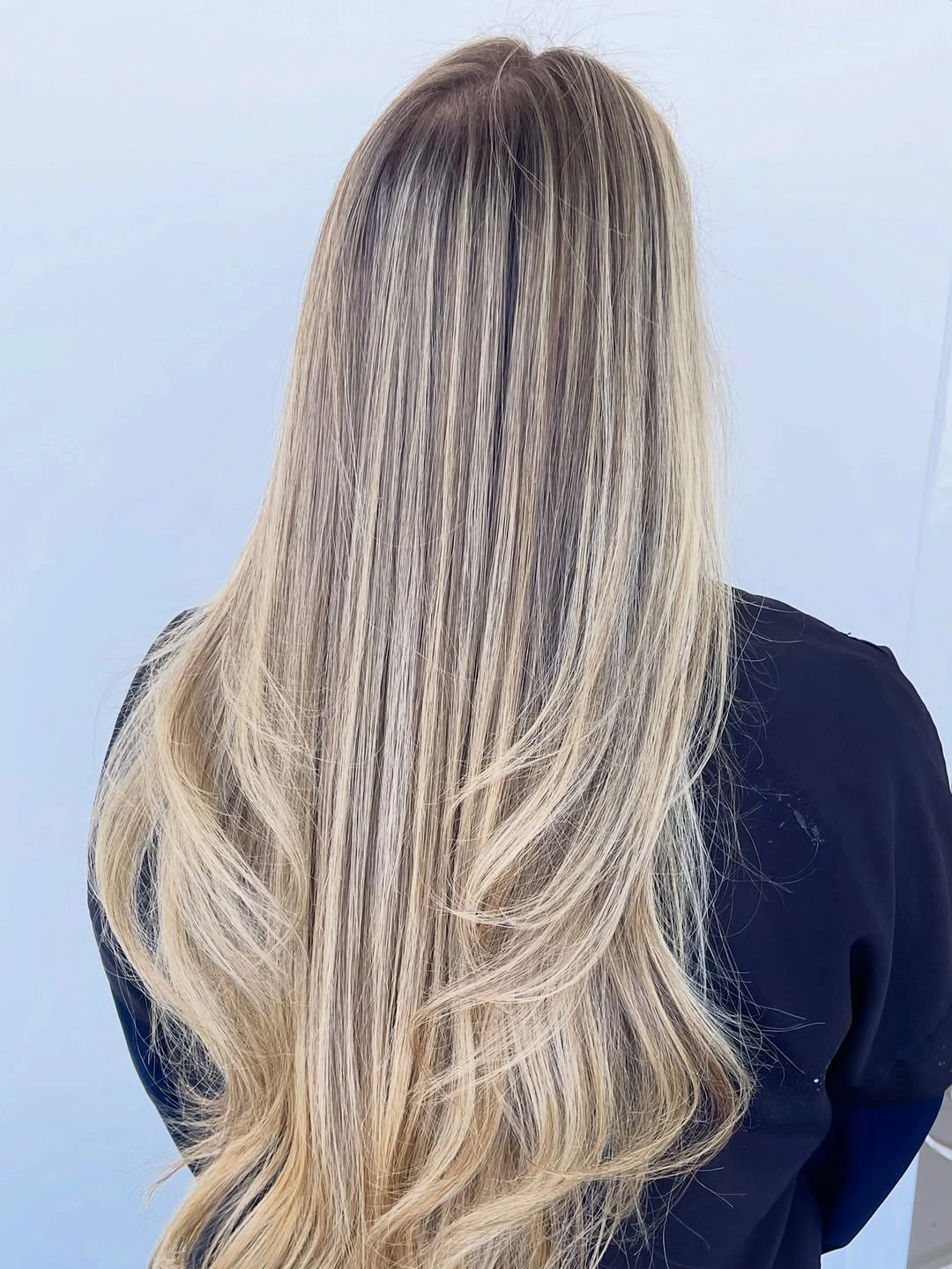 Long layered blonde hair with darker vertical lowlights