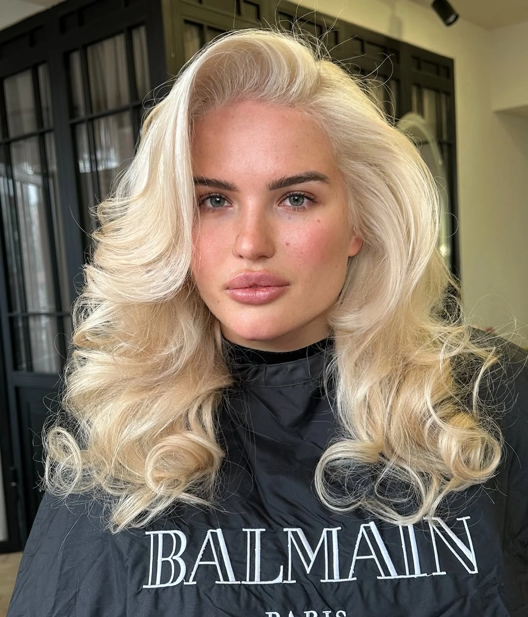Creamy blonde curls with high side volume