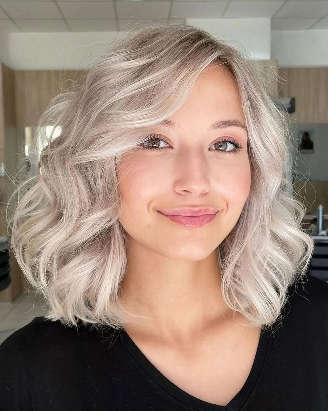 Medium wavy pearl blonde lob with side-swept front