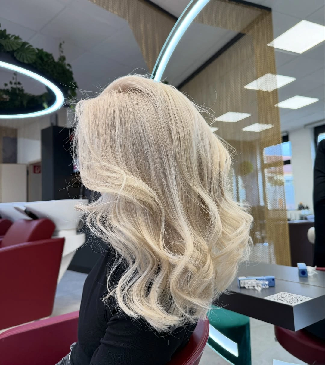 Back view of cool blonde waves with darker roots