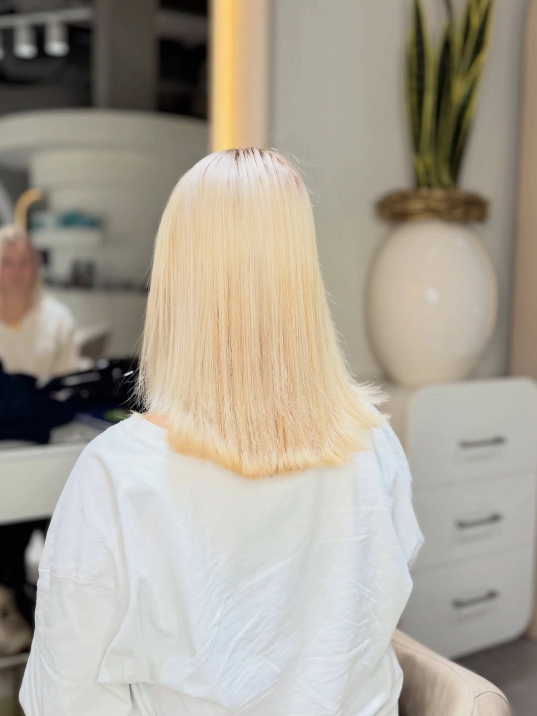Straight shoulder-length pale golden blonde hair from back
