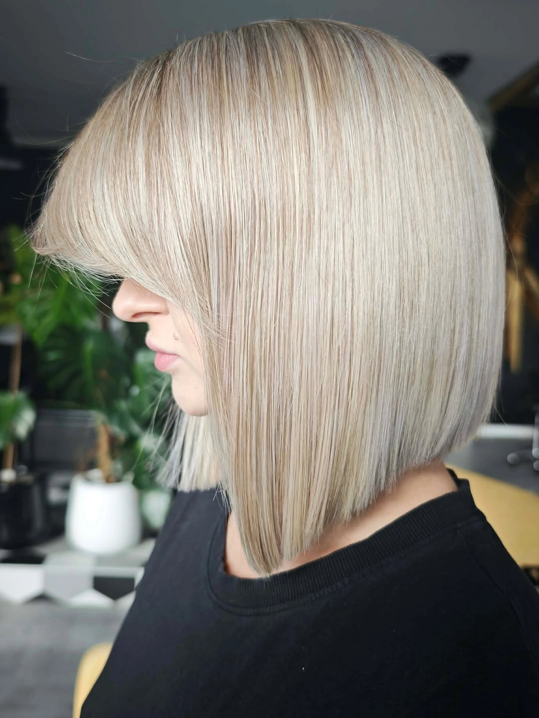 Sleek blonde bob with full bangs and rounded back