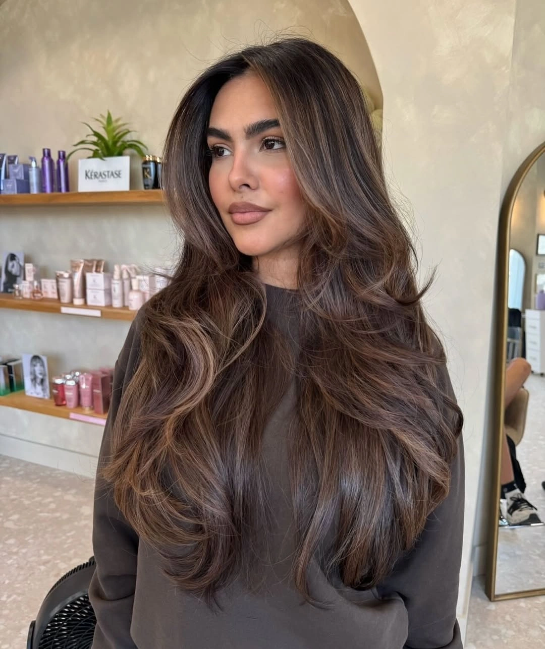Long layered brunette hair with soft beige-brown ribbons
