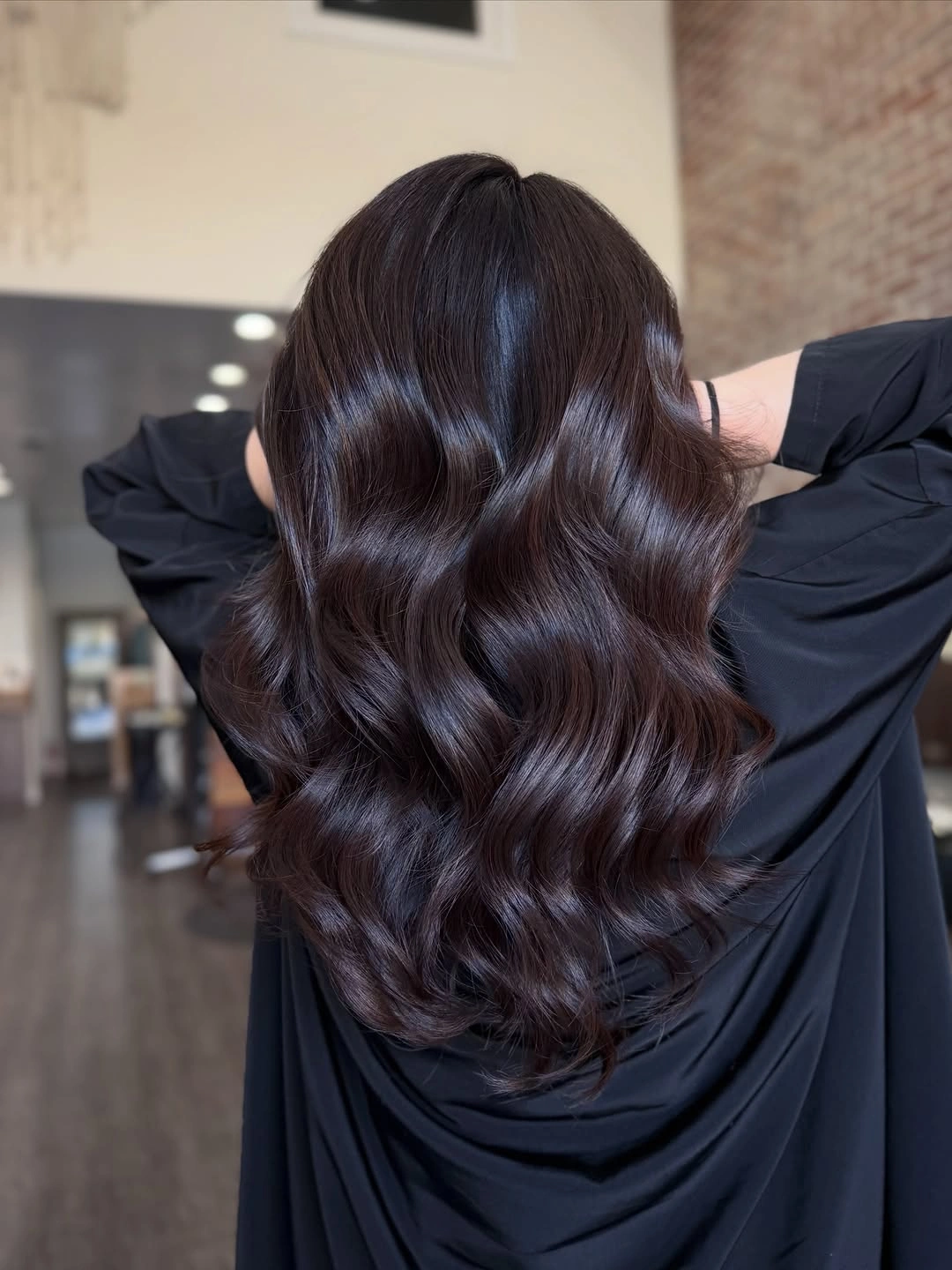 Long espresso brunette waves with subtle burgundy gloss