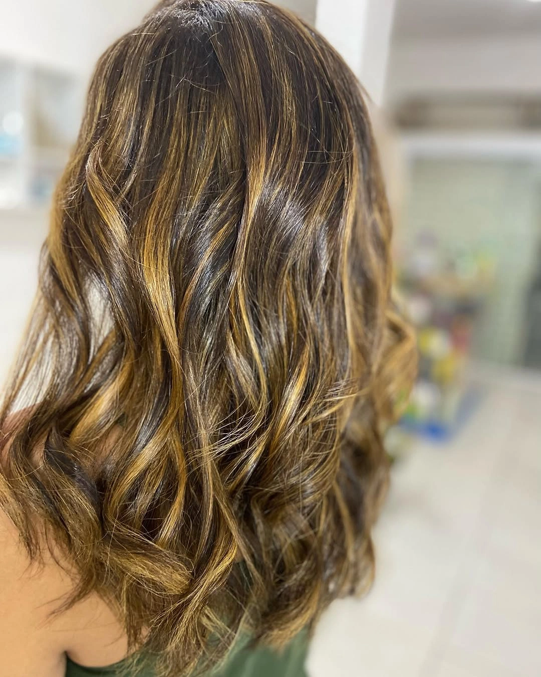 Medium brunette waves with golden and beige highlighted ribbons