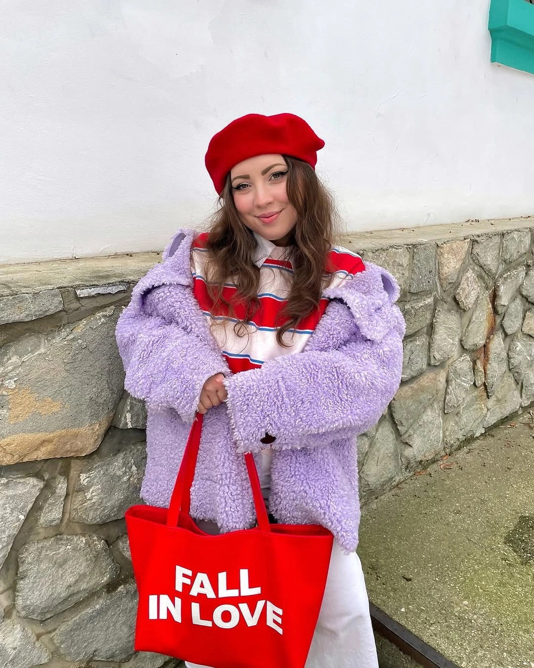 Lavender fuzzy jacket, striped red white blue top, red beret, red tote, and white trousers.