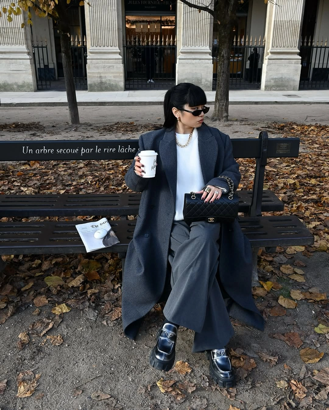 Blue-gray coat, white top, wide gray trousers, black loafers