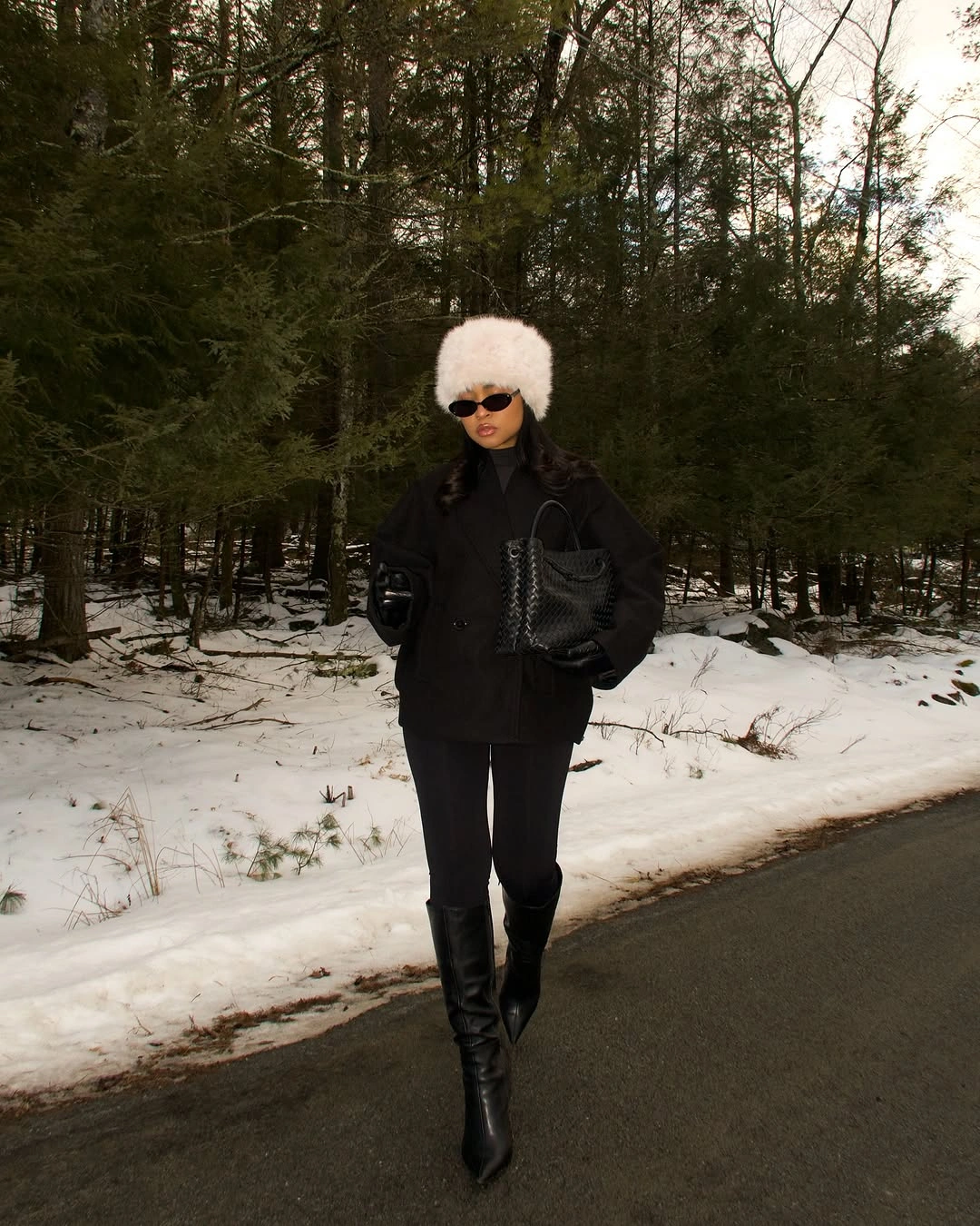 White fluffy hat with black coat and tall boots
