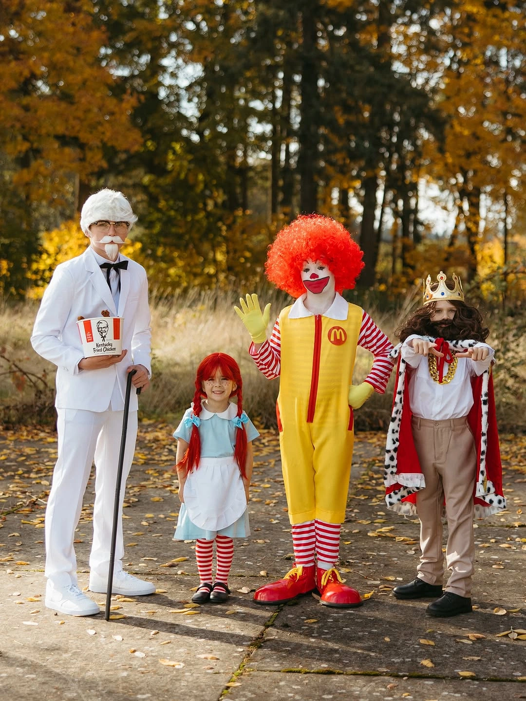 Family in white red and striped comic uniform-inspired Halloween costumes