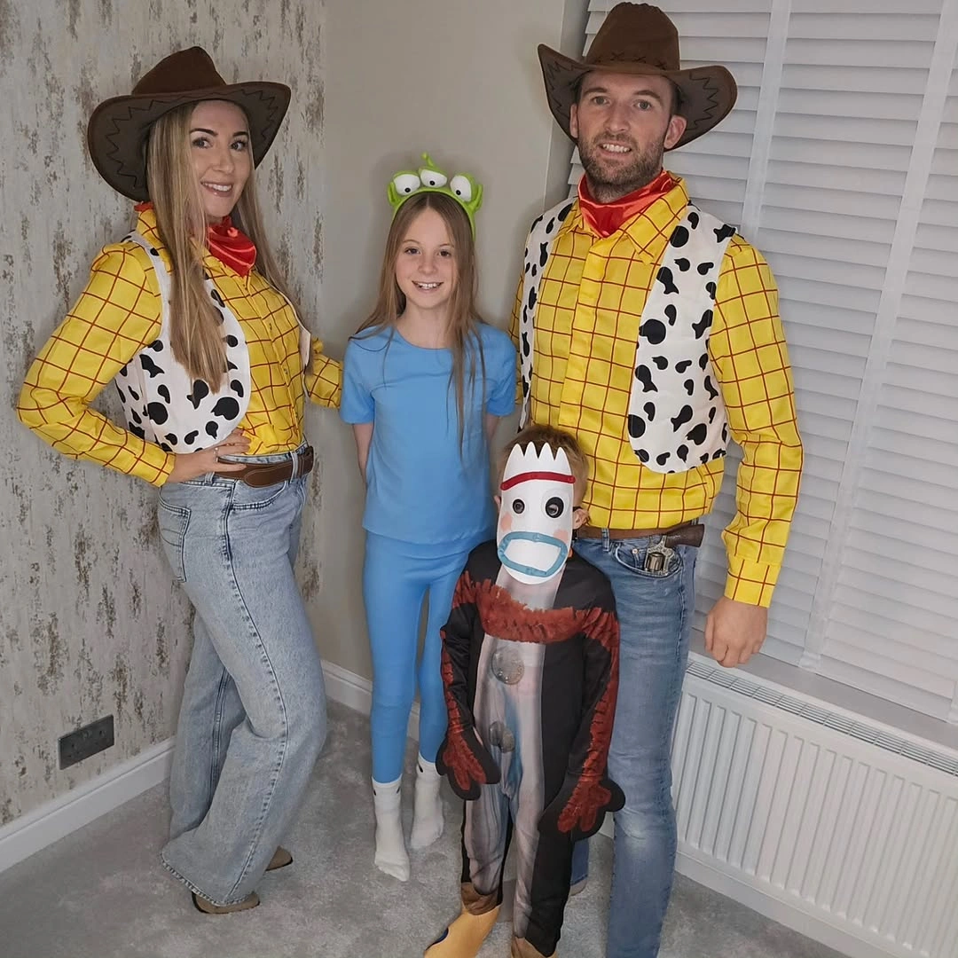 Parents and child in yellow checked western Halloween costumes with cow-print details