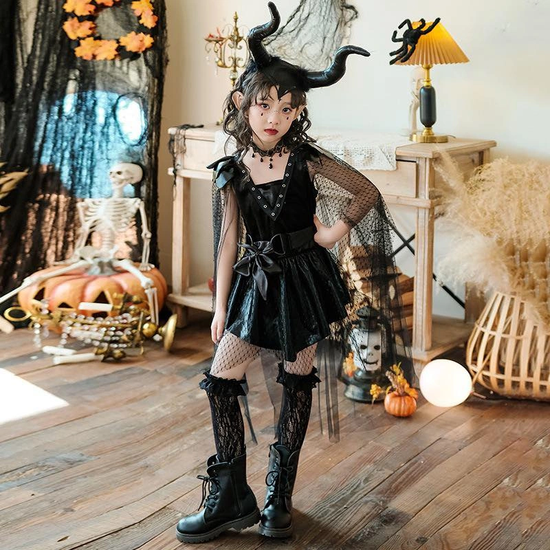Girl in black horned fantasy Halloween dress with mesh sleeves and tall boots
