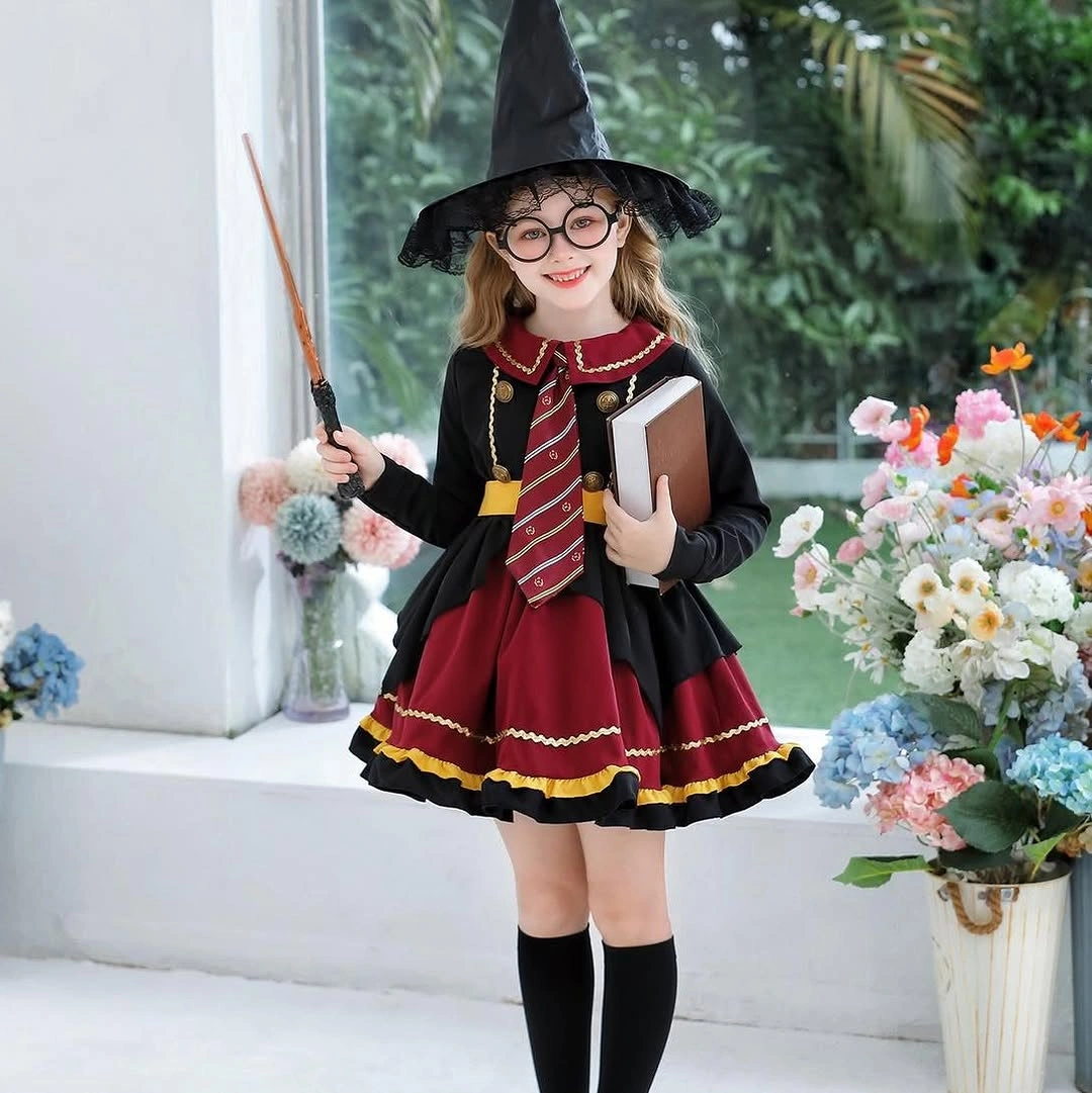 Girl in black witch-school costume with pointed hat striped scarf round glasses book and wand