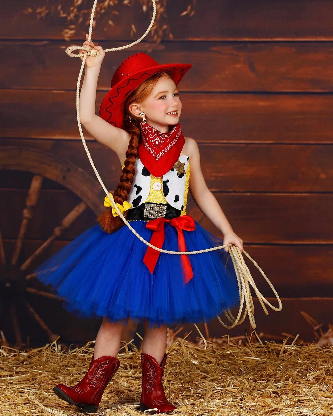 Girl in red cowgirl hat bandana spotted vest blue tulle skirt and boots