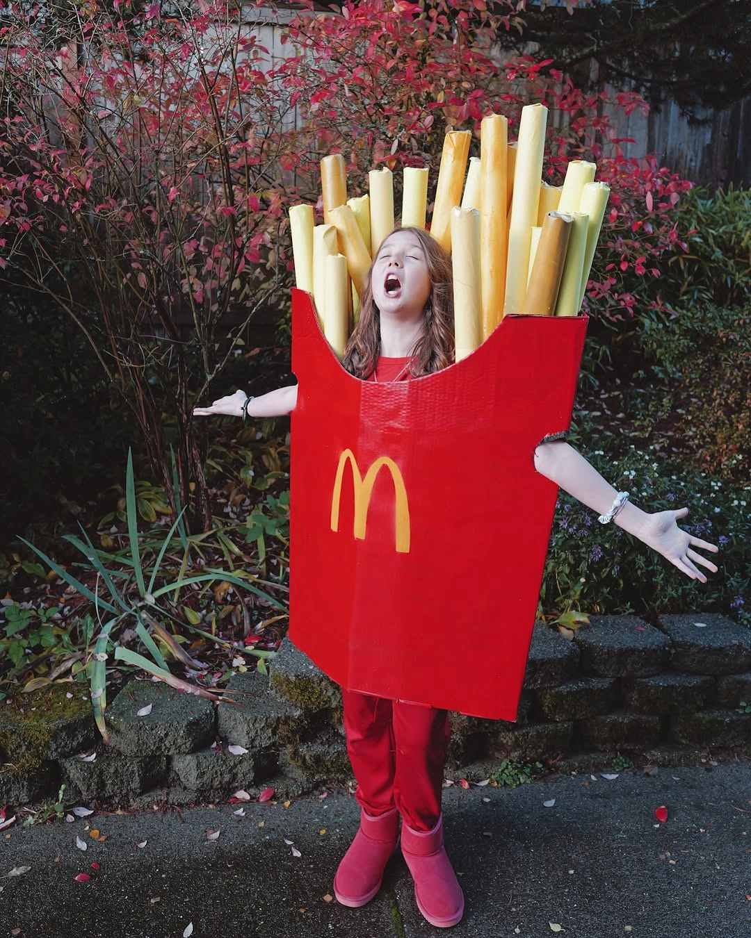 Girl wearing oversized red fries box costume with yellow foam fries
