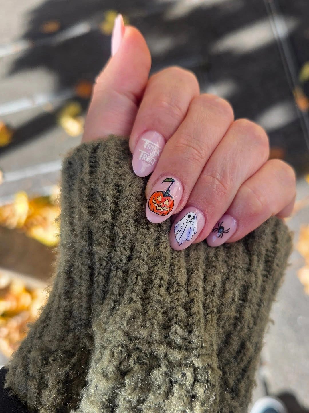 Medium almond nails with black orange curved blocks and pumpkin designs