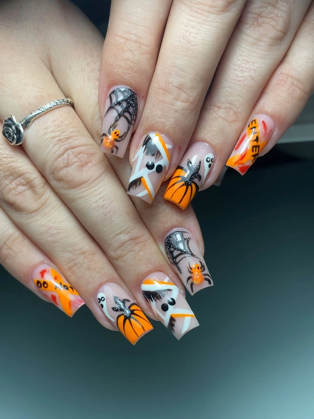 Medium square gray nails with spiderwebs ghosts orange pumpkins and drips