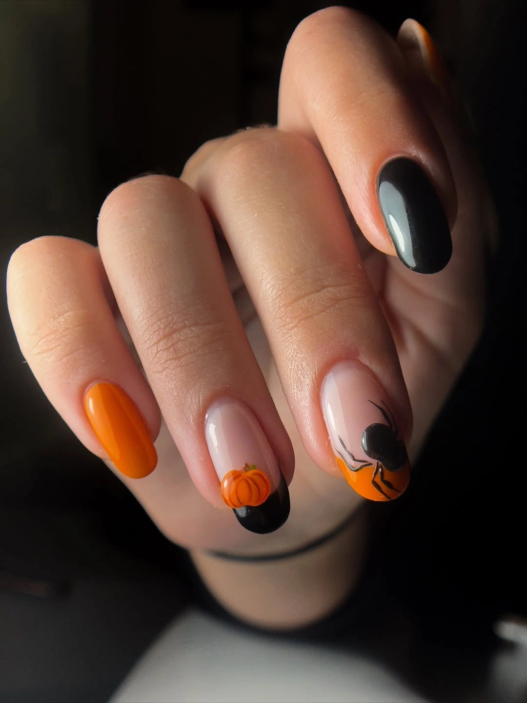 Short nude nails with blue tips tiny pumpkins and colorful Halloween face art