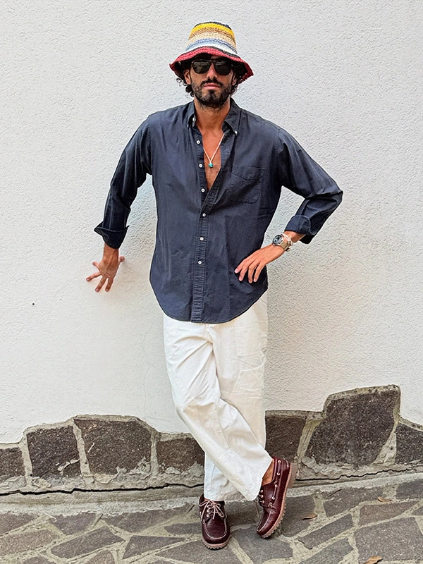 Dark navy open shirt white trousers striped hat and burgundy loafers