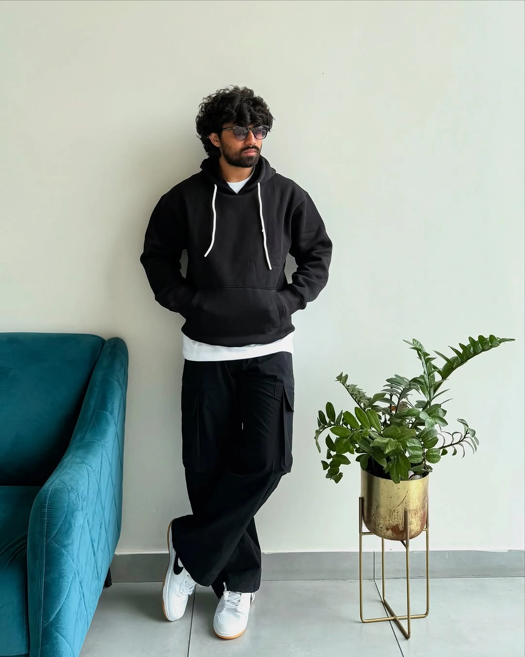 Black zip hoodie loose black trousers white tee hem and sneakers