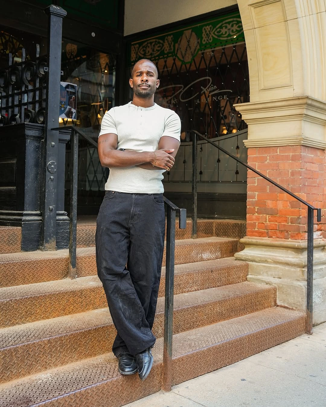 Fitted white T-shirt with wide charcoal trousers and black shoes