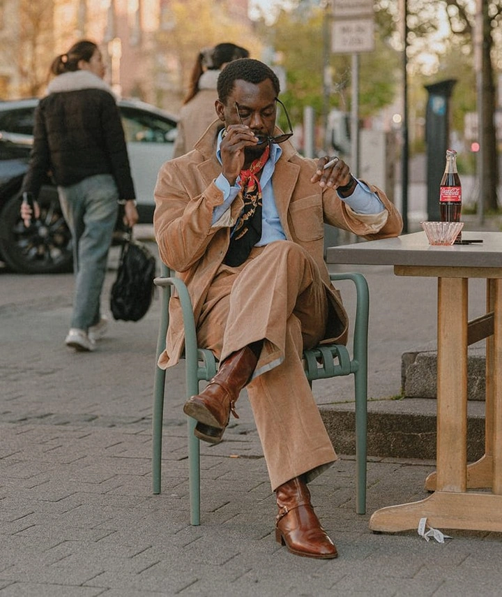 Camel suit with colorful scarf brown boots and sunglasses