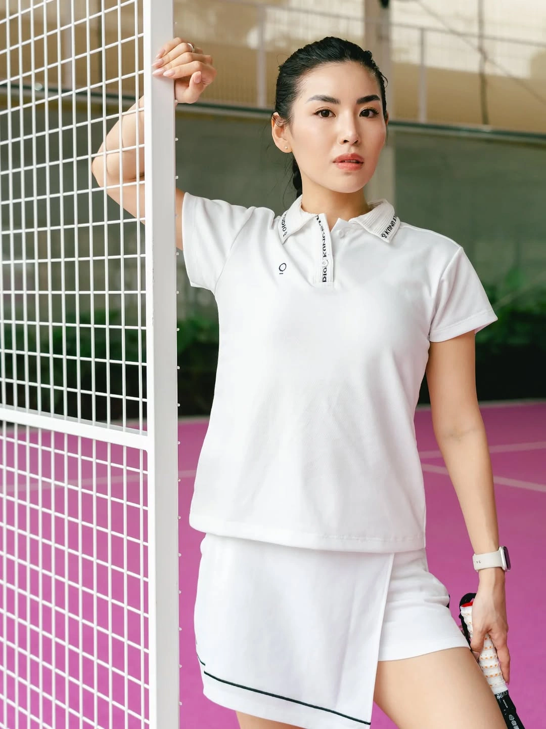 White polo and piped shorts for a women's padel outfit