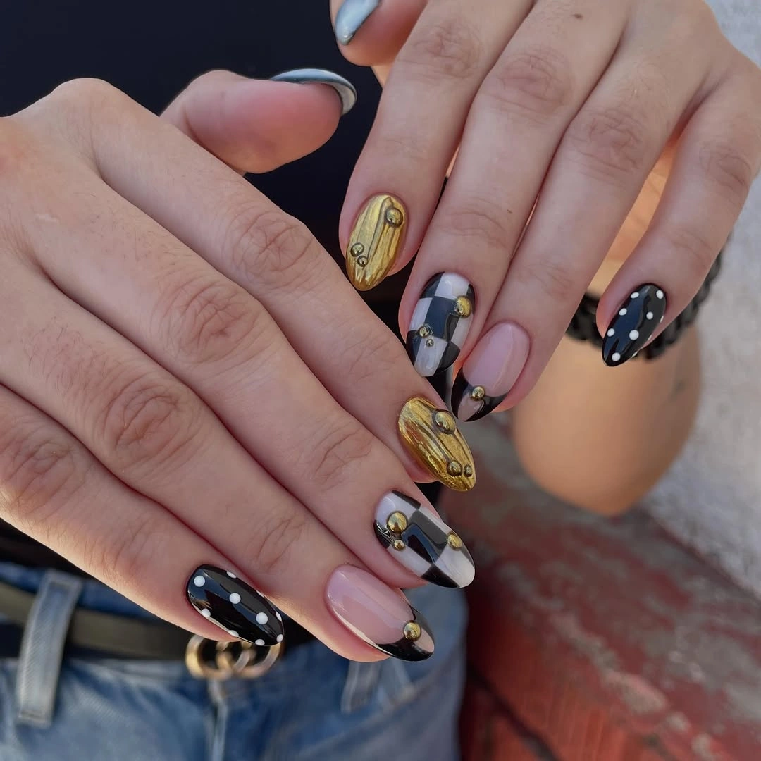 Mixed nude black yellow gray and white nails with black dotted tips and graphic accent designs