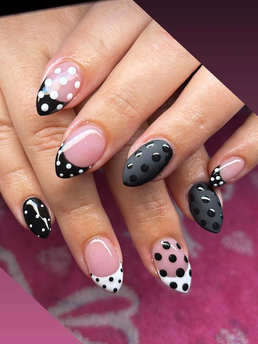 Nude almond nails with narrow white French tips and small black dotted borders