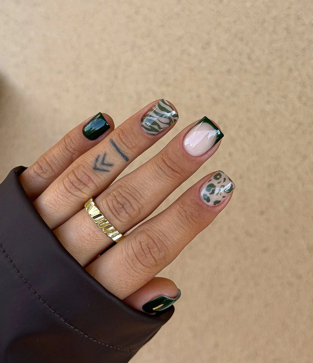 Short squared nails with black green and spotted designs