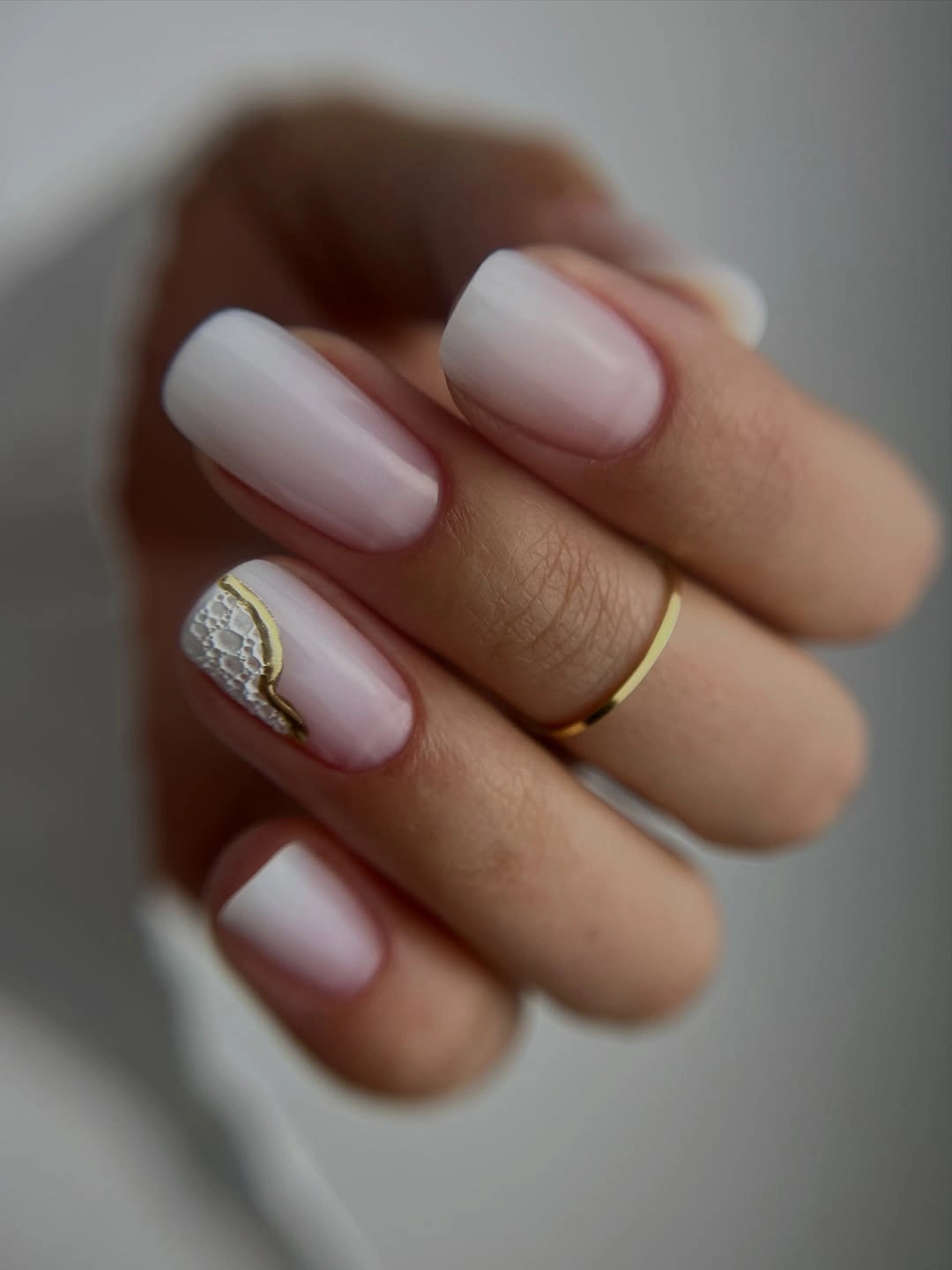 Medium-to-long milky blush nails with white net accent