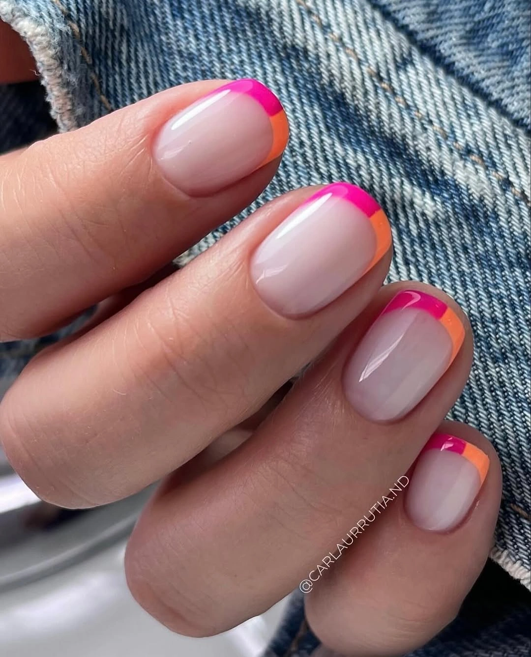 Short rounded nails with pink and orange French tips