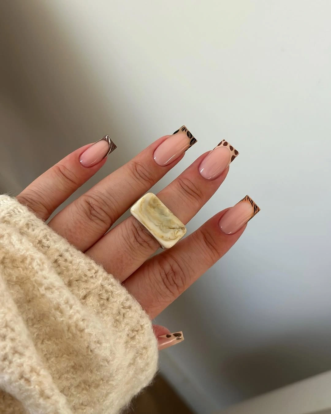 Nude squared nails with brown and black patterned tips