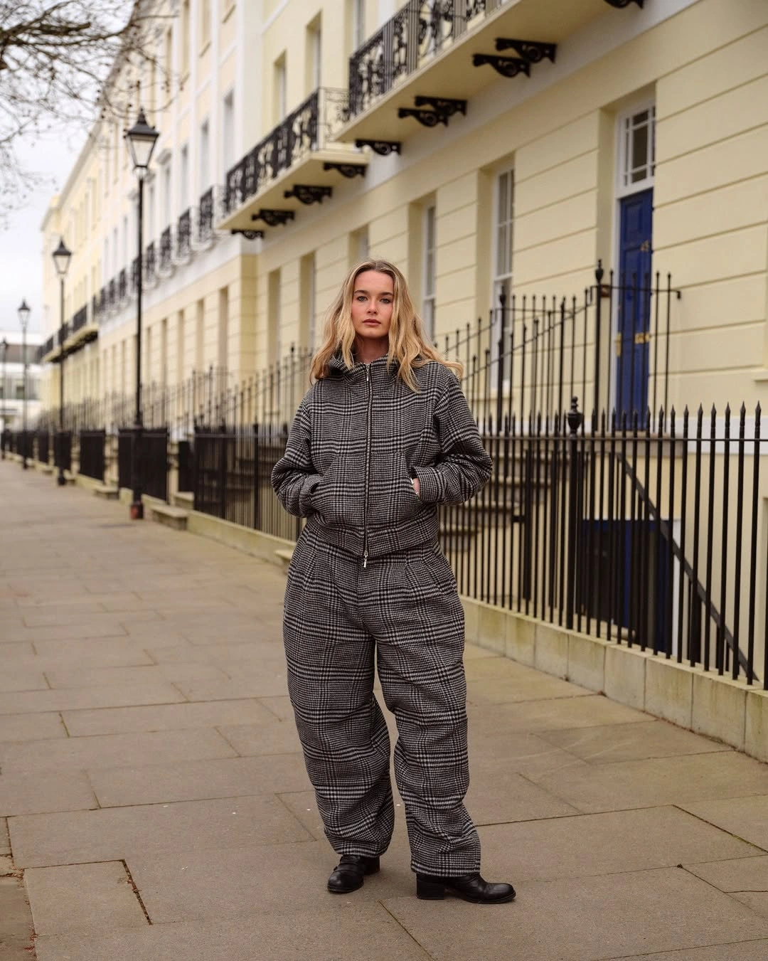 Gray checked jacket and matching loose trousers with clean white sneakers