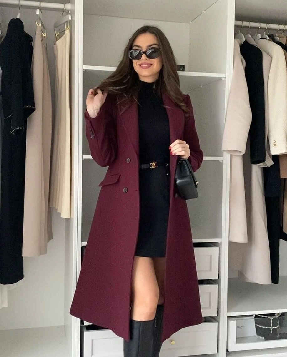 Burgundy long coat with black turtleneck and tall boots