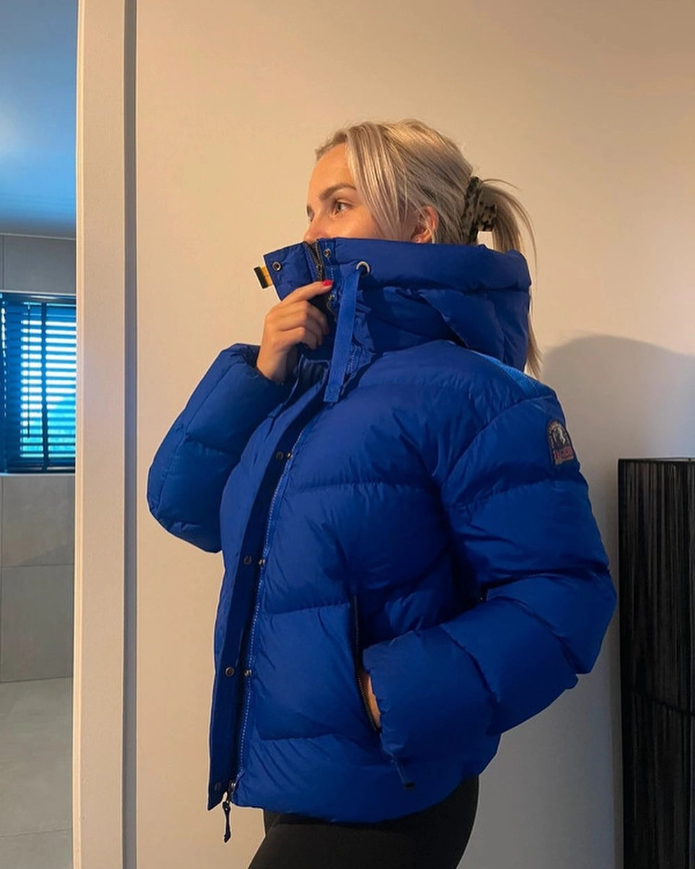 Royal blue cropped puffer with high collar and black leggings
