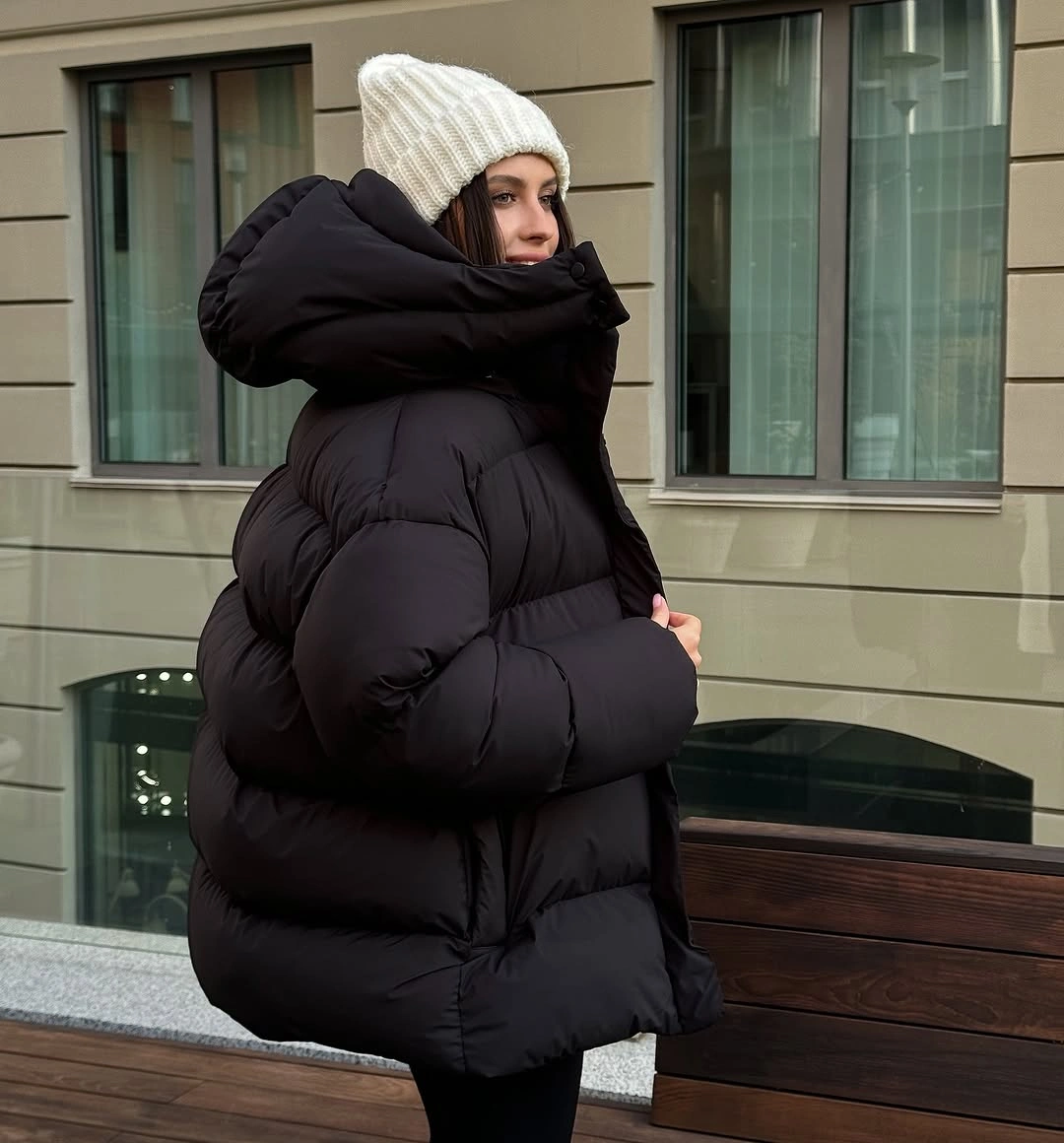 Oversized black puffer with pale beanie and slim black base