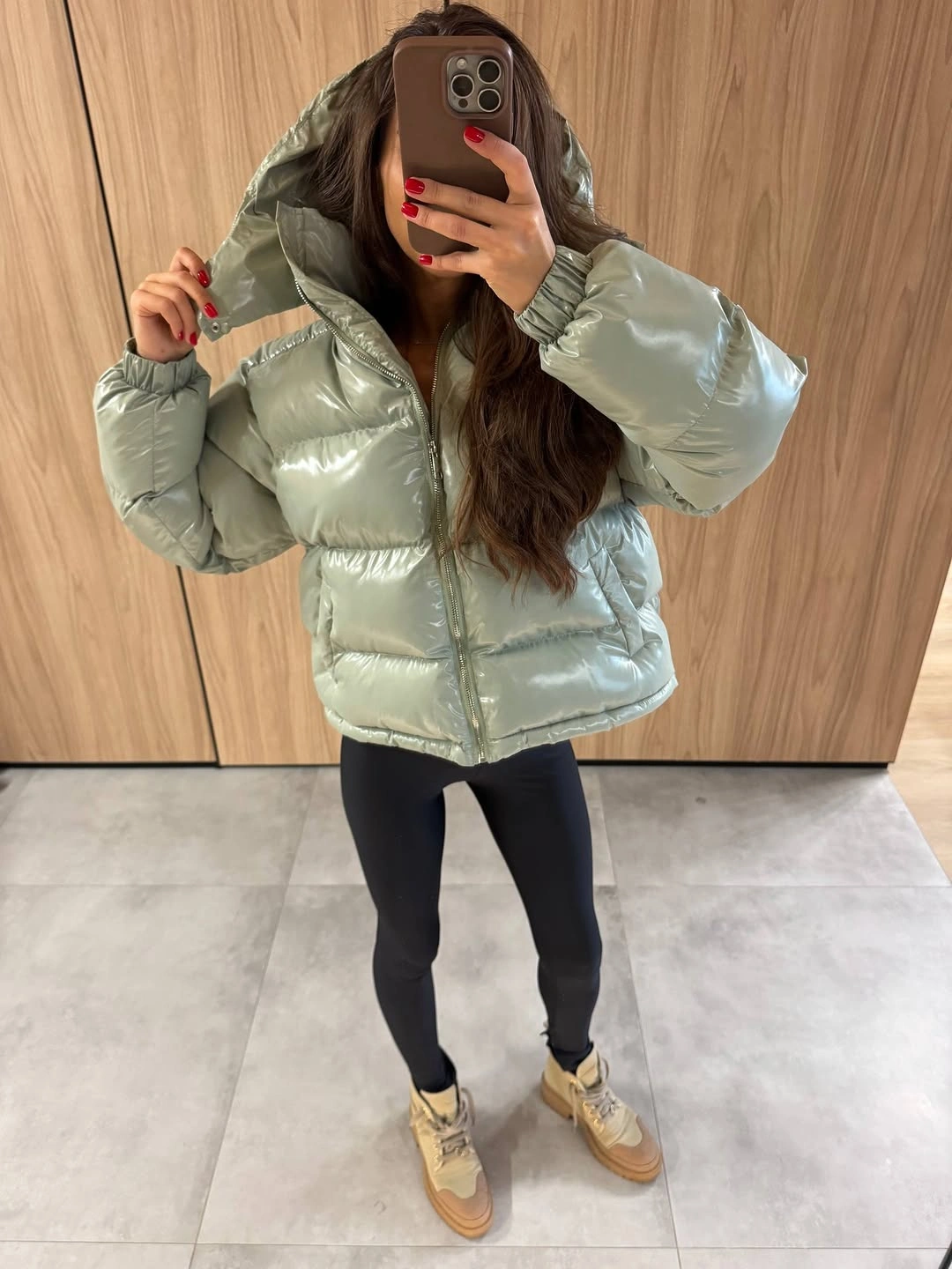 Pale mint glossy puffer with black leggings and tan footwear