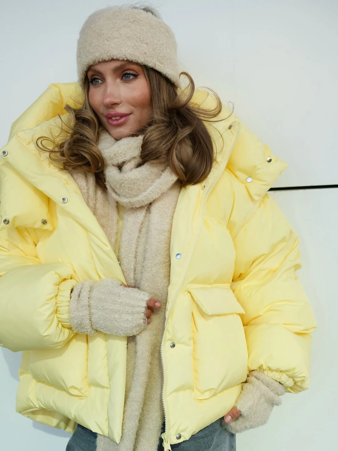 Pale yellow cropped puffer with cream hat and scarf