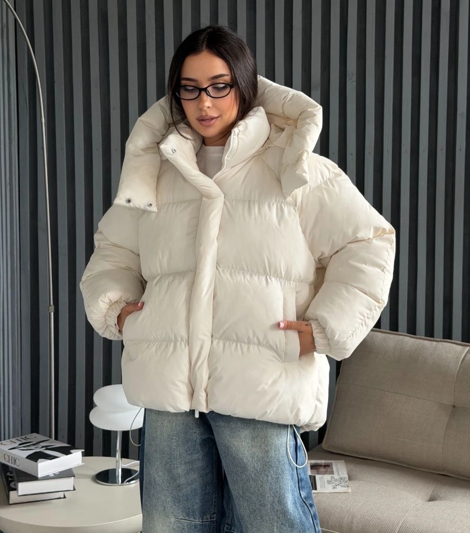 White hooded puffer jacket with wide gray jeans