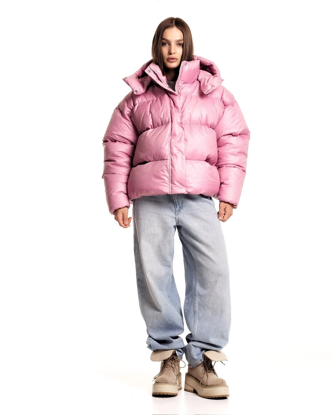 Pink cropped puffer with loose gray jeans and beige boots