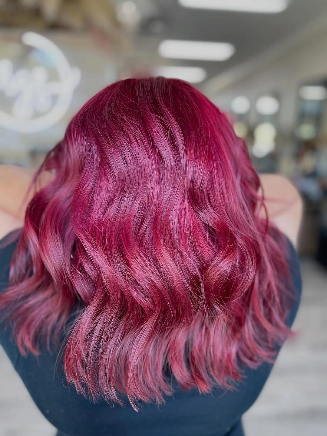 Back view of magenta shoulder-length waves with layered ends