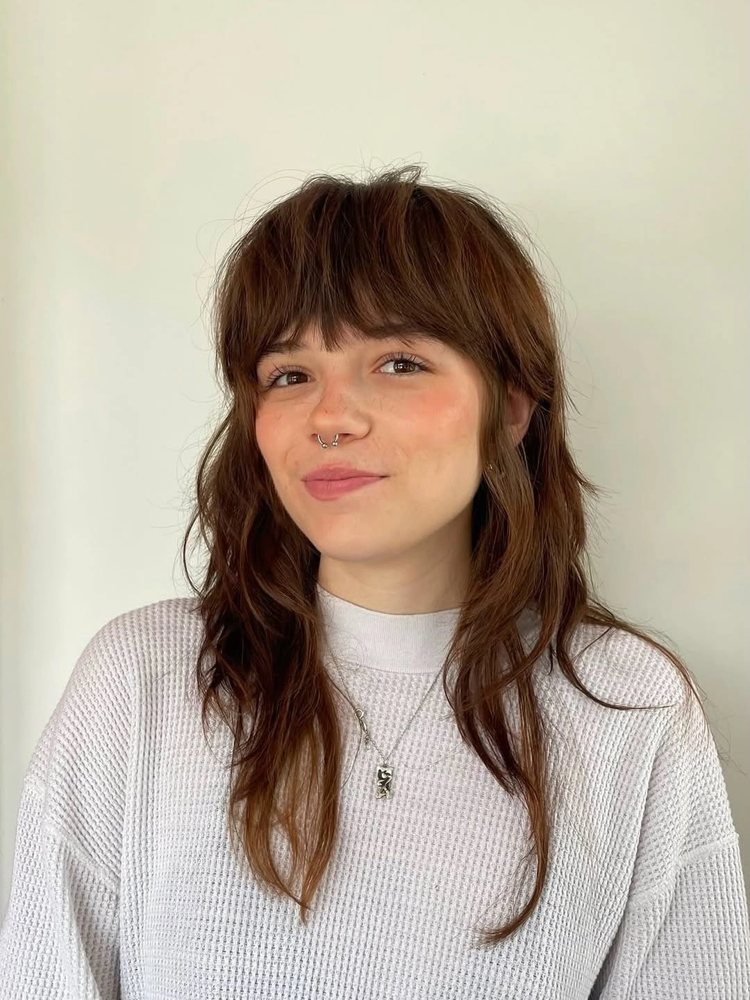 Long brown shag with full bangs and face-framing layers