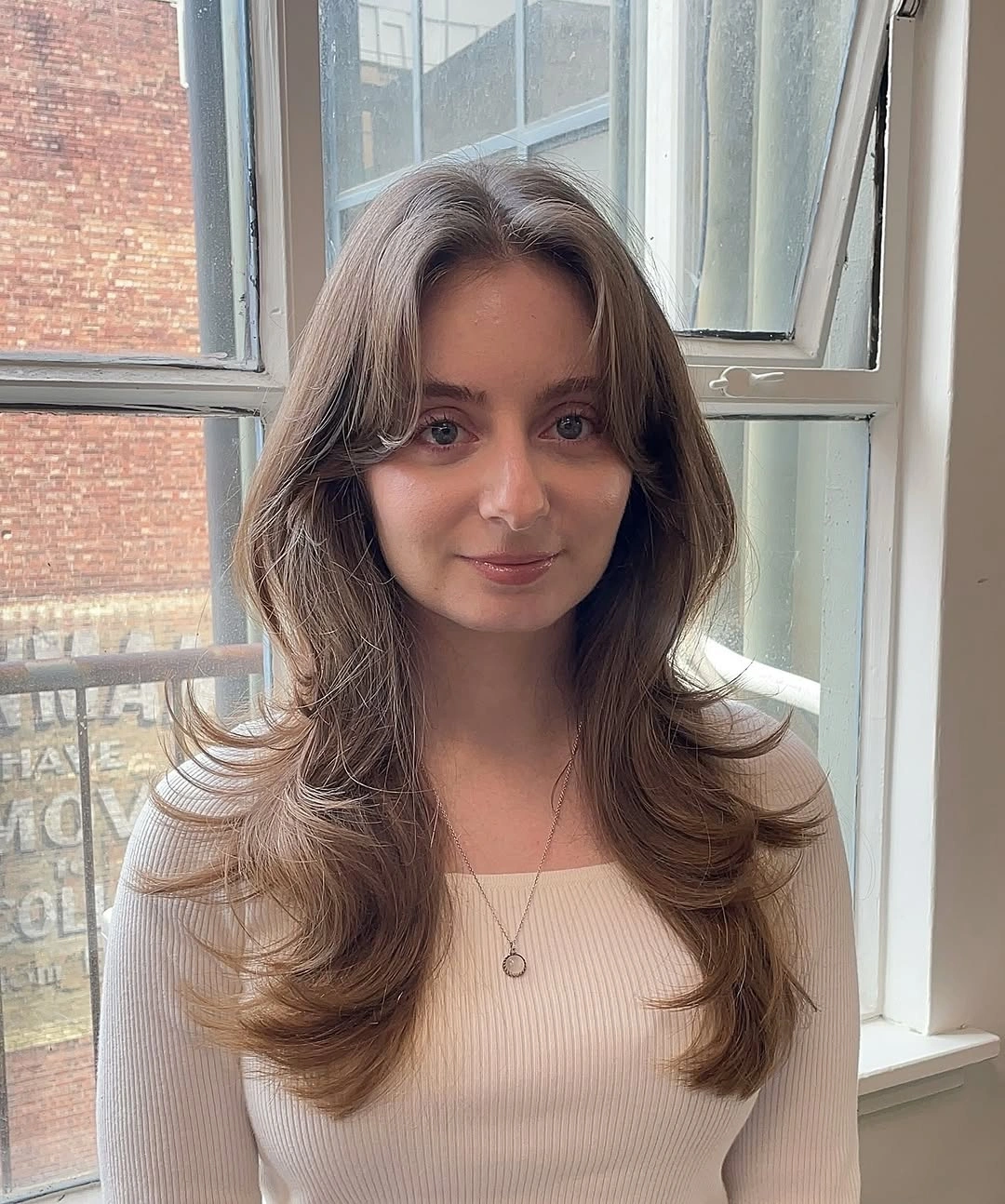 Long brown layers with center part and sweeping front pieces